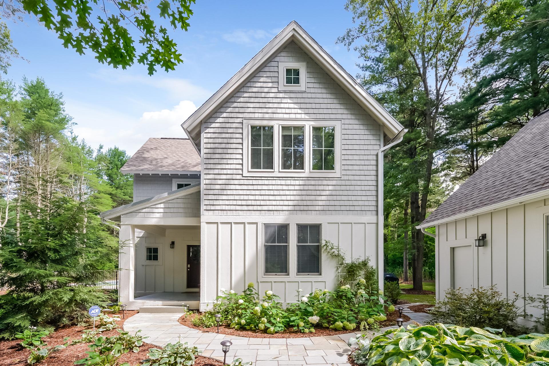 Lake Trail Treehouse, a Quaint Cottages property in Saugatuck, surrounded by trees and landscaped gardens.